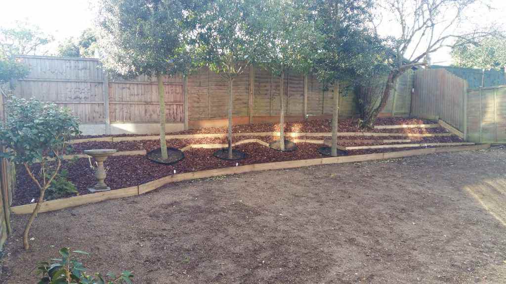 Decorative chipped bark applied across garden bank