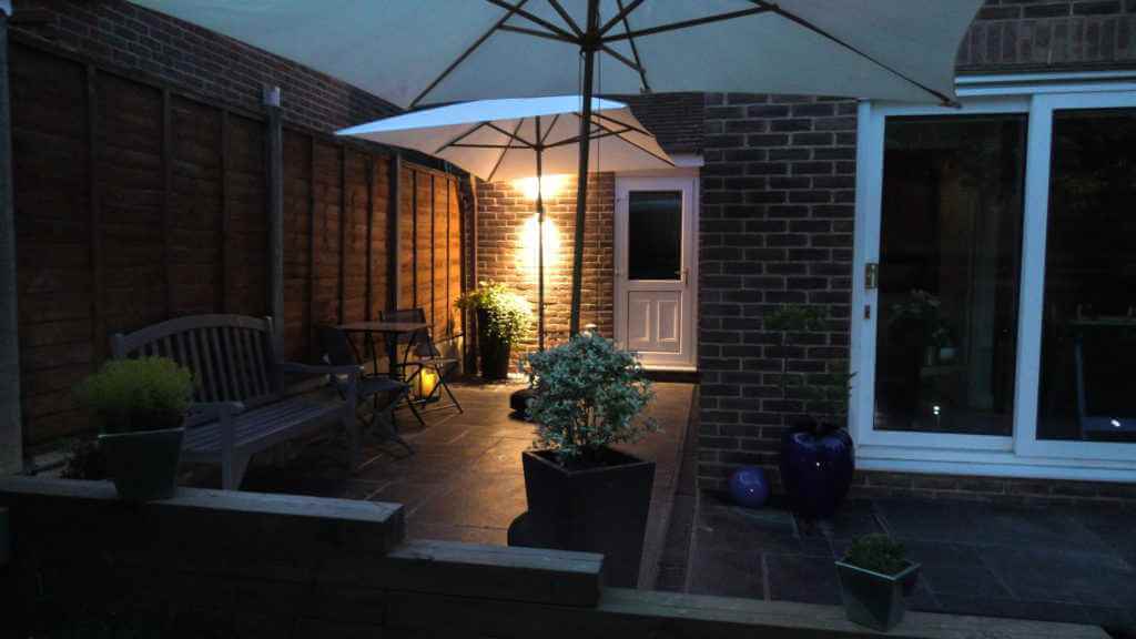 View of patio at night viewed from the lawn