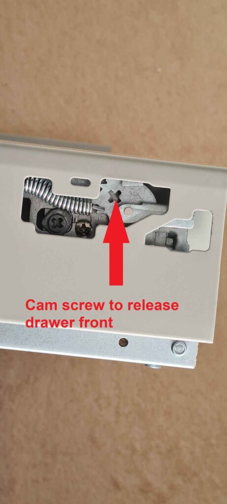 Drawer cam screw used to release drawer front.