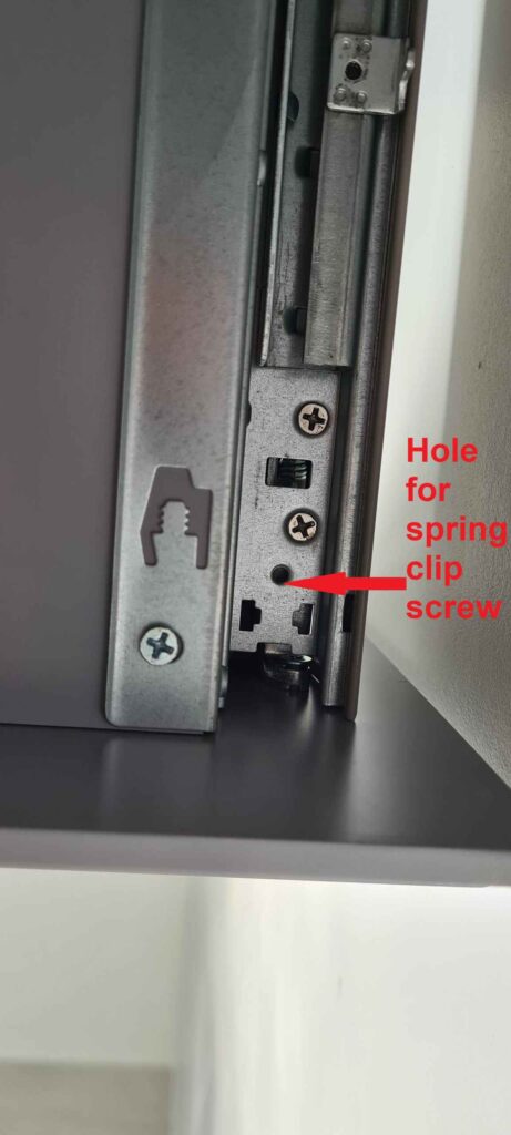 Drawer rail showing hole where fixing screw goes to secure spring clip.