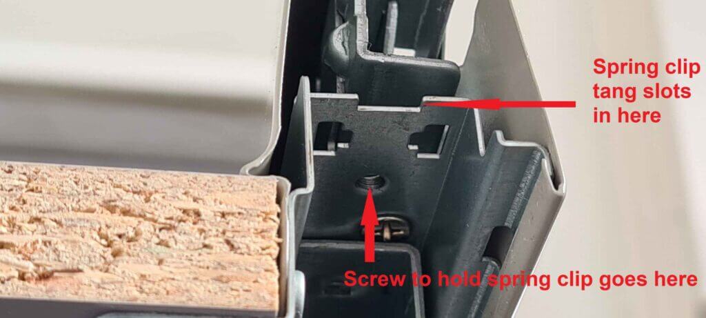 Elements of the drawer rail that accept the spring clip that holds the drawer in place.