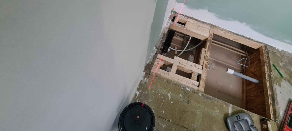 Using laser level to lineup shower tray drain