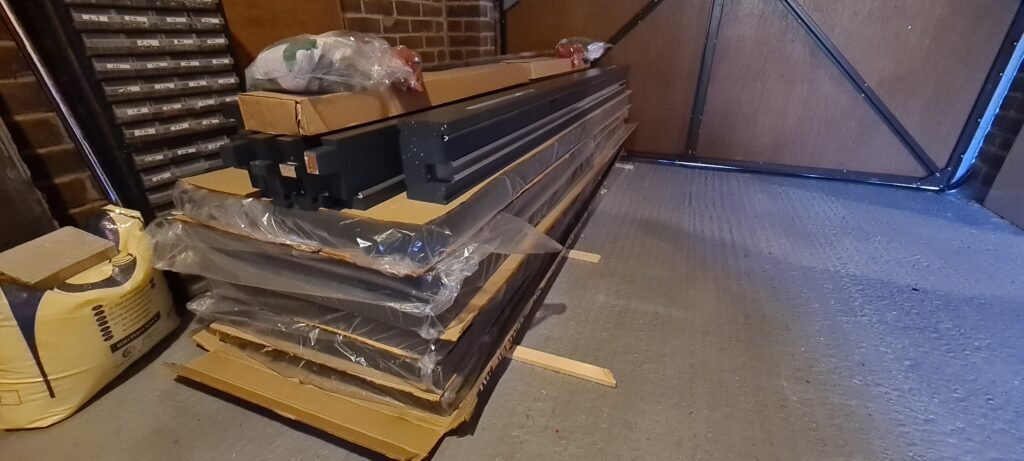 Two sets of Jeld-Wen Bedgebury bifold doors unpackaged and ticked off against the kit list