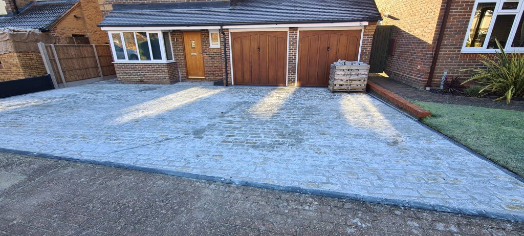 Driveway granite cobbles laid and pointed before cleanup operation