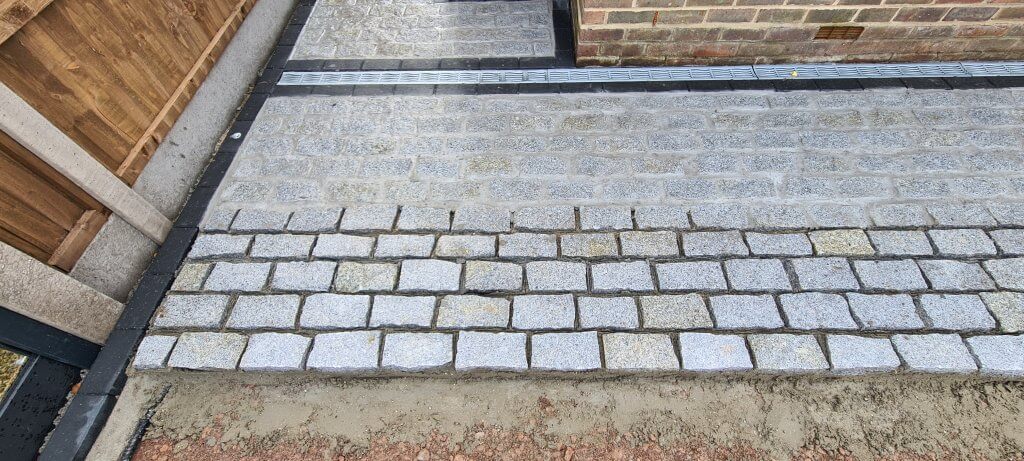 Granite cobble setts being laid and then grouted 24 hours later