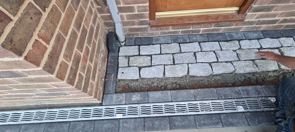 Granite cobble setts being laid in porch area