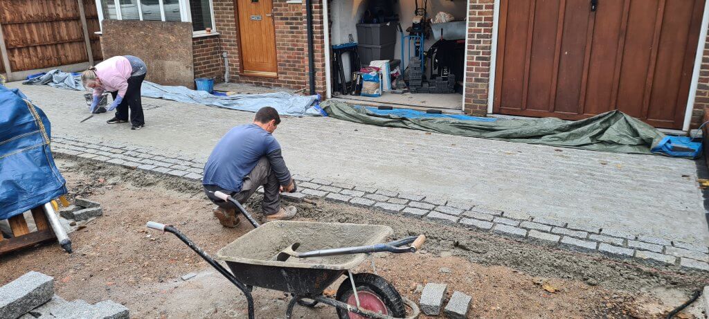 Laying cobbles and striking off the grout