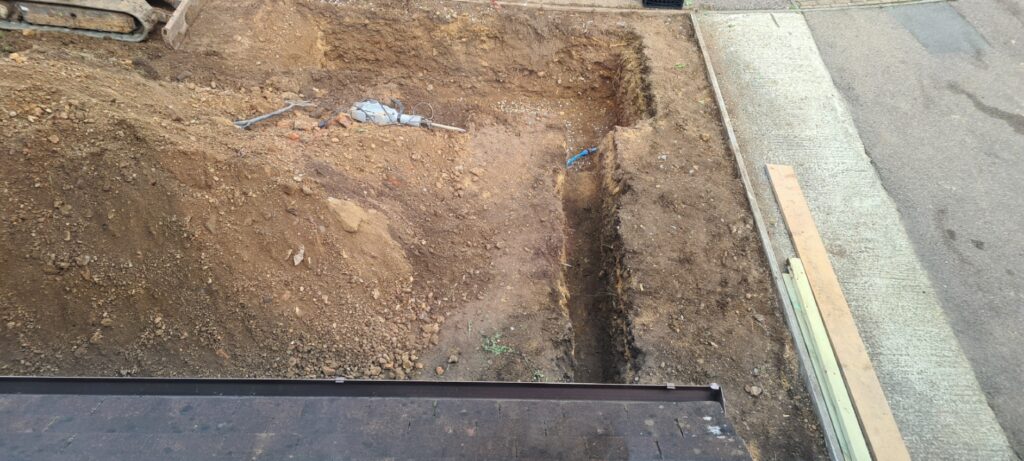Soak away pit and newly dug trench for drainage pipe