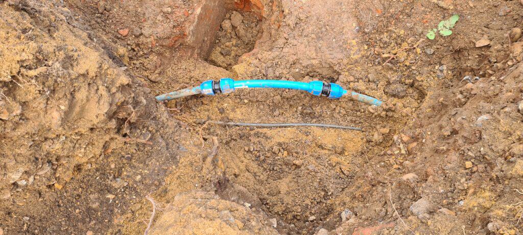 The blue water main pipe repaired with new piece of pipe and two 25mm screw fit couplers