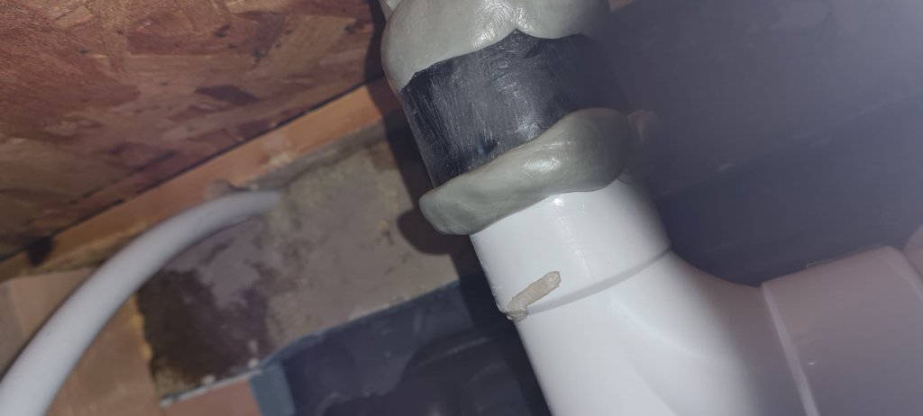 Two part epoxy putty pressed in place to seal leaking pipe joint