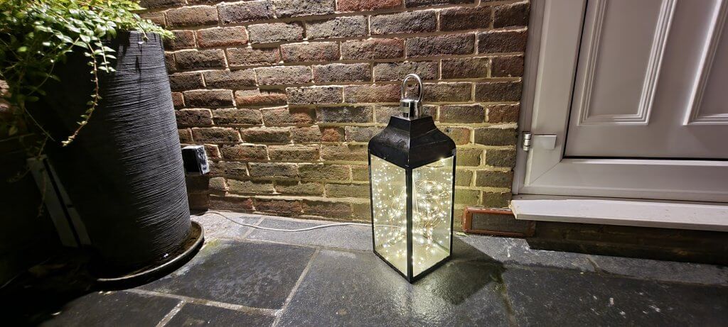 Chrome storm lantern containing 10m of 100 led usb powered warm white string fairy lights on shapable copper Cable